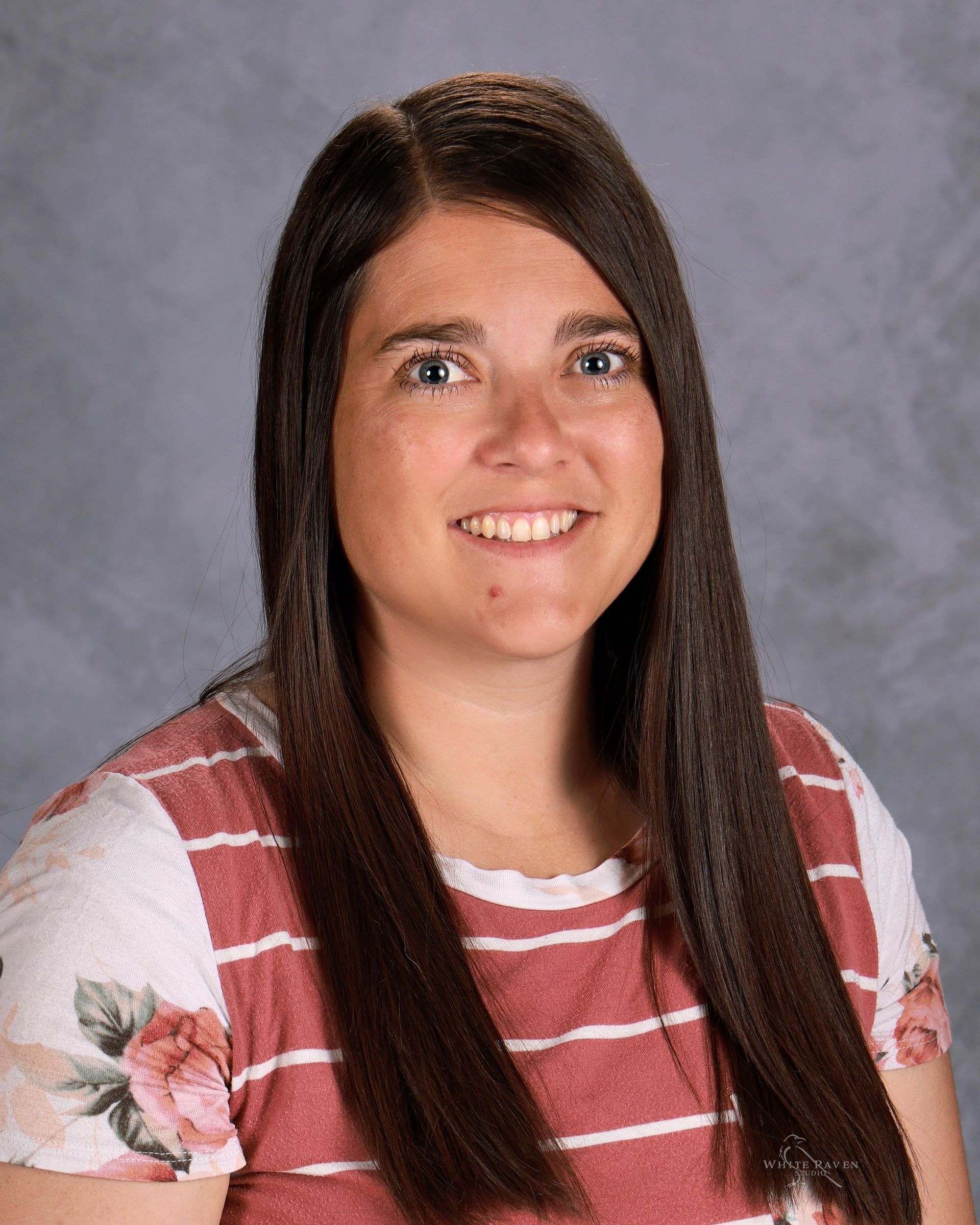 Woman in striped shirt smiling at camera