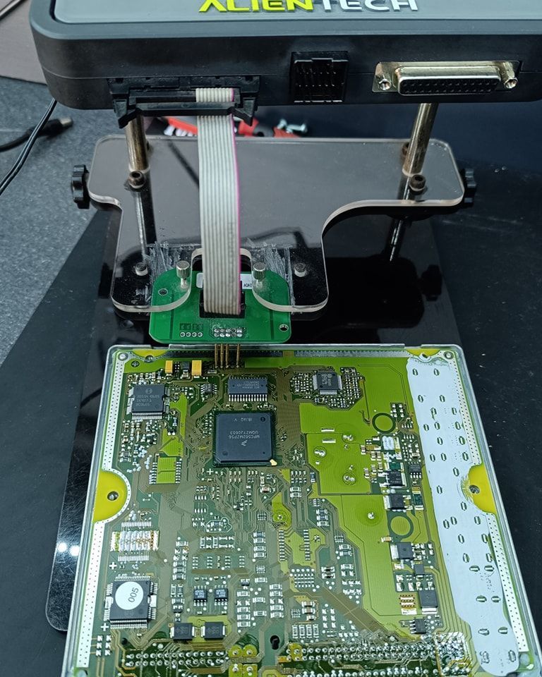 A motherboard is sitting on top of an alientech device