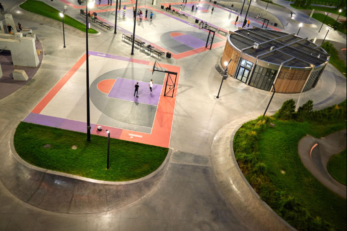 Aerial view of colorful outdoor basketball and recreation courts inside a landscaped sports park during a court installation service in Peoria, AZ