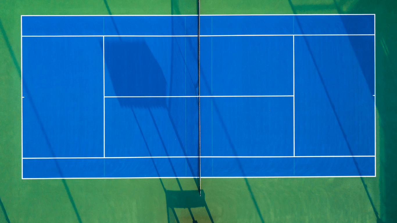 Overhead view of a freshly lined blue tennis court with crisp white boundaries during a court installation service in Peoria, AZ