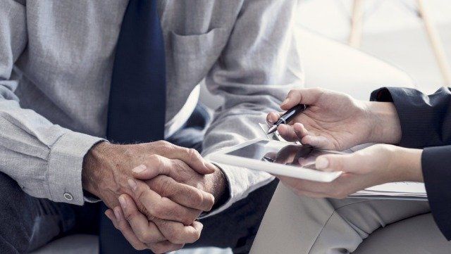 2 People Sitting Down Having A Meeting