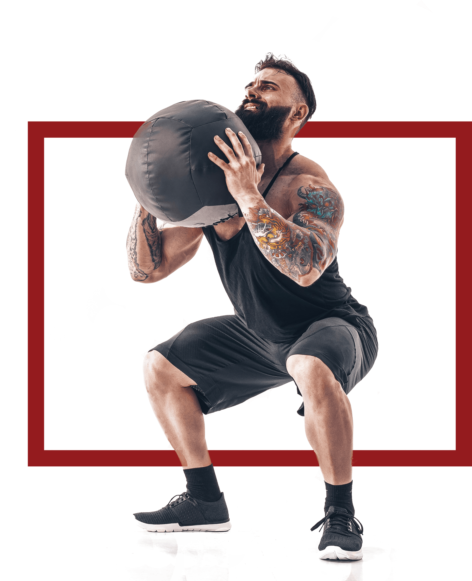 Muscular tattooed bearded male exercising fitness weights Medicine Ball