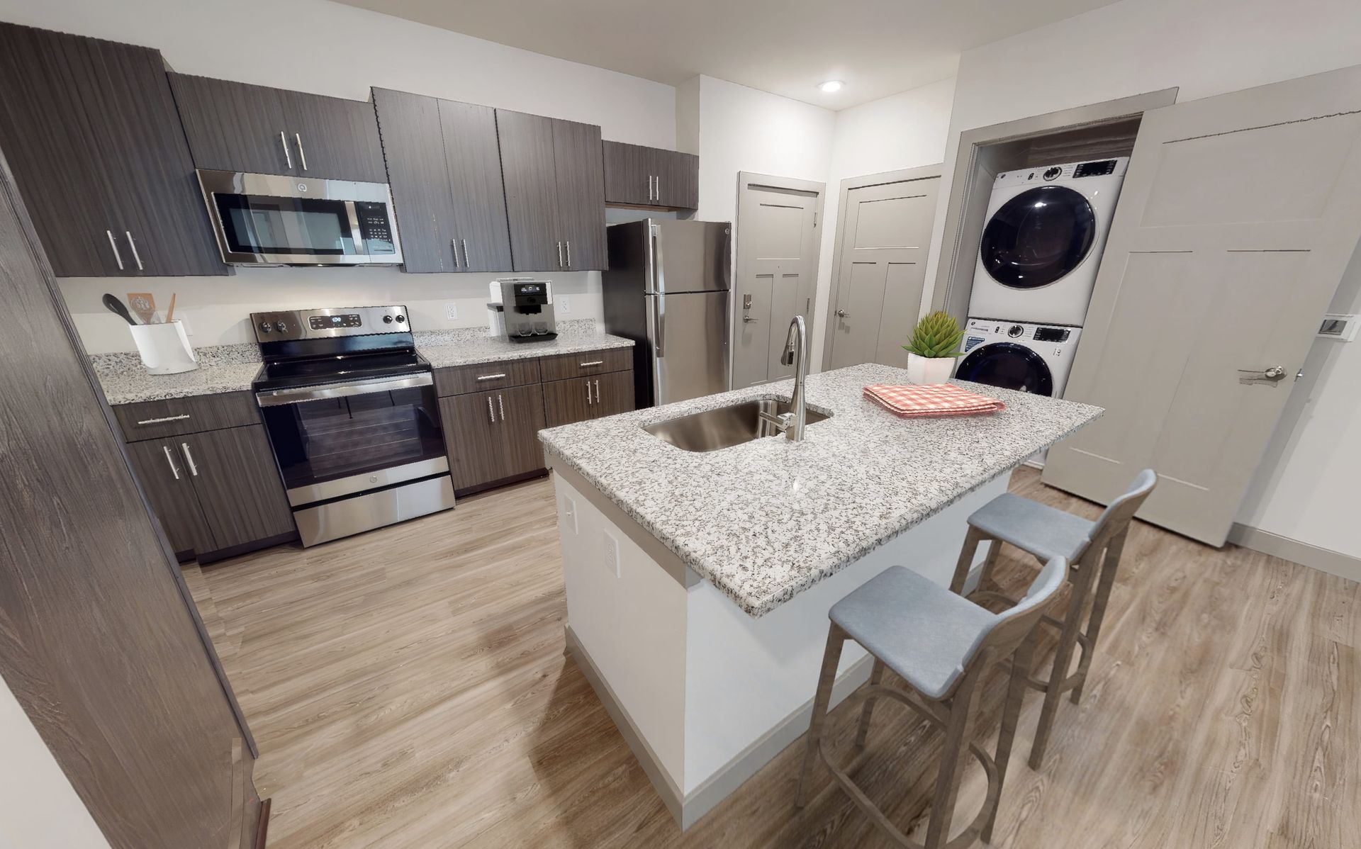 A kitchen with stainless steel appliances and granite counter tops