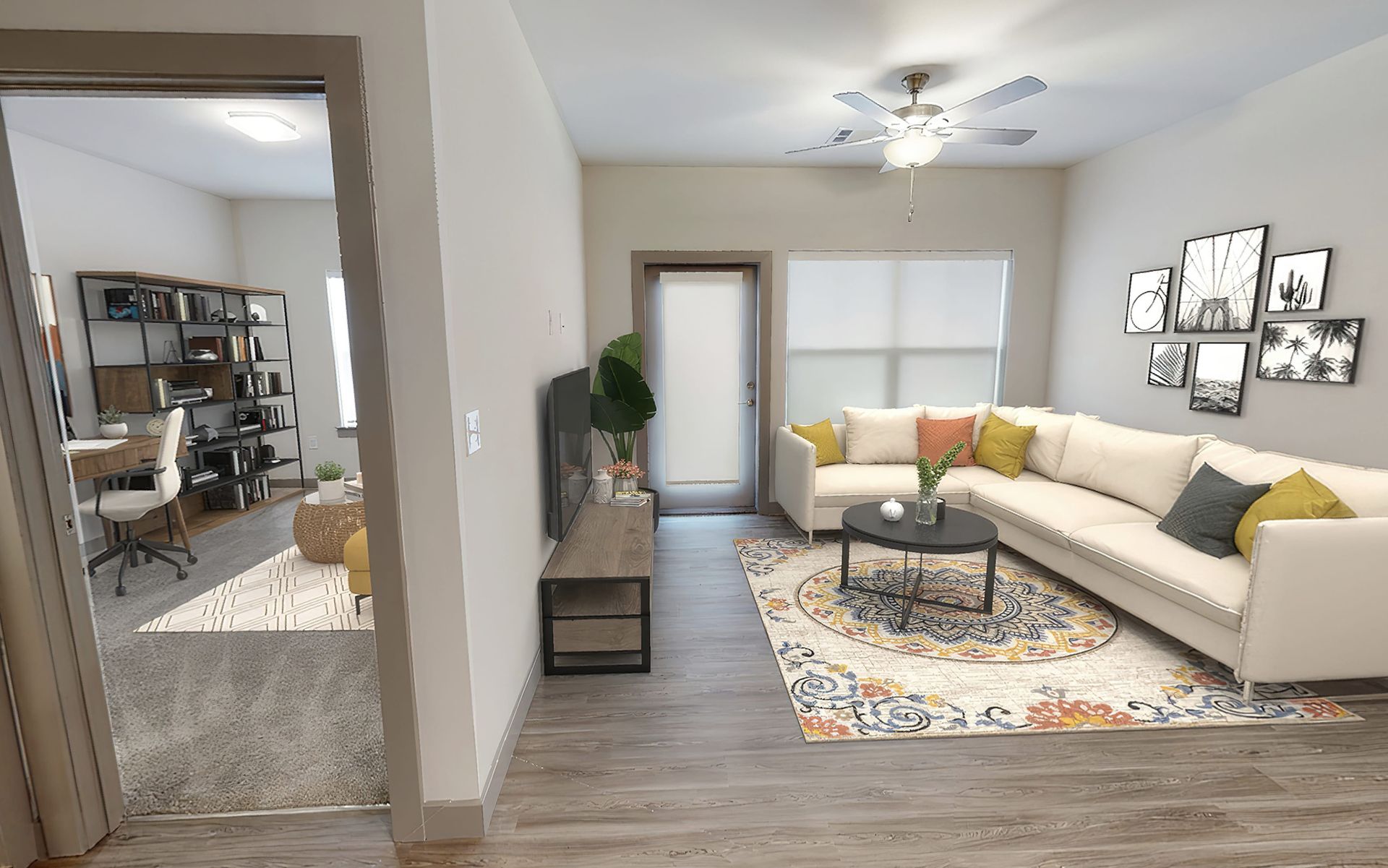 A living room with a large sectional couch and a ceiling fan.