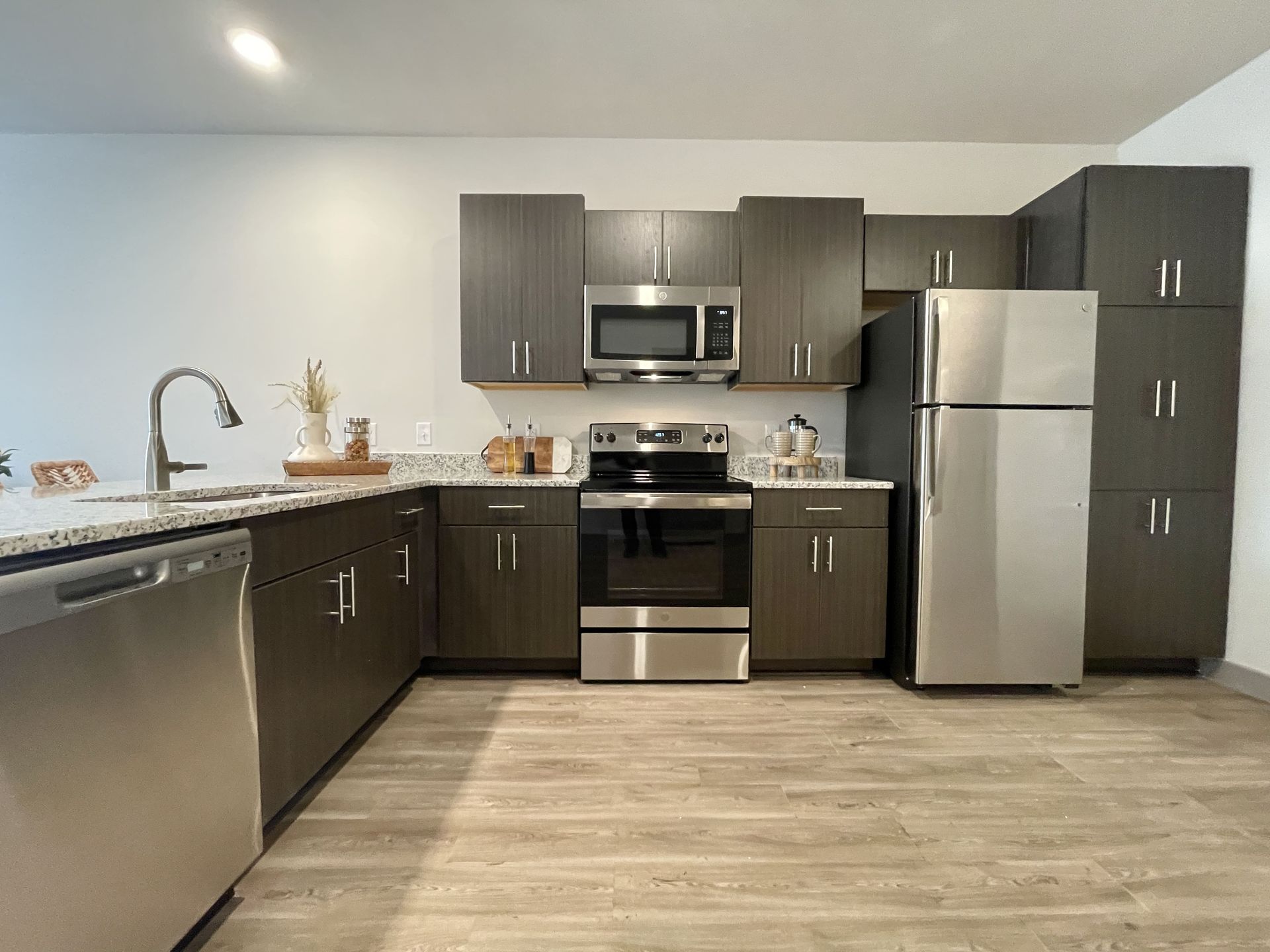 A kitchen with stainless steel appliances and wooden cabinets.