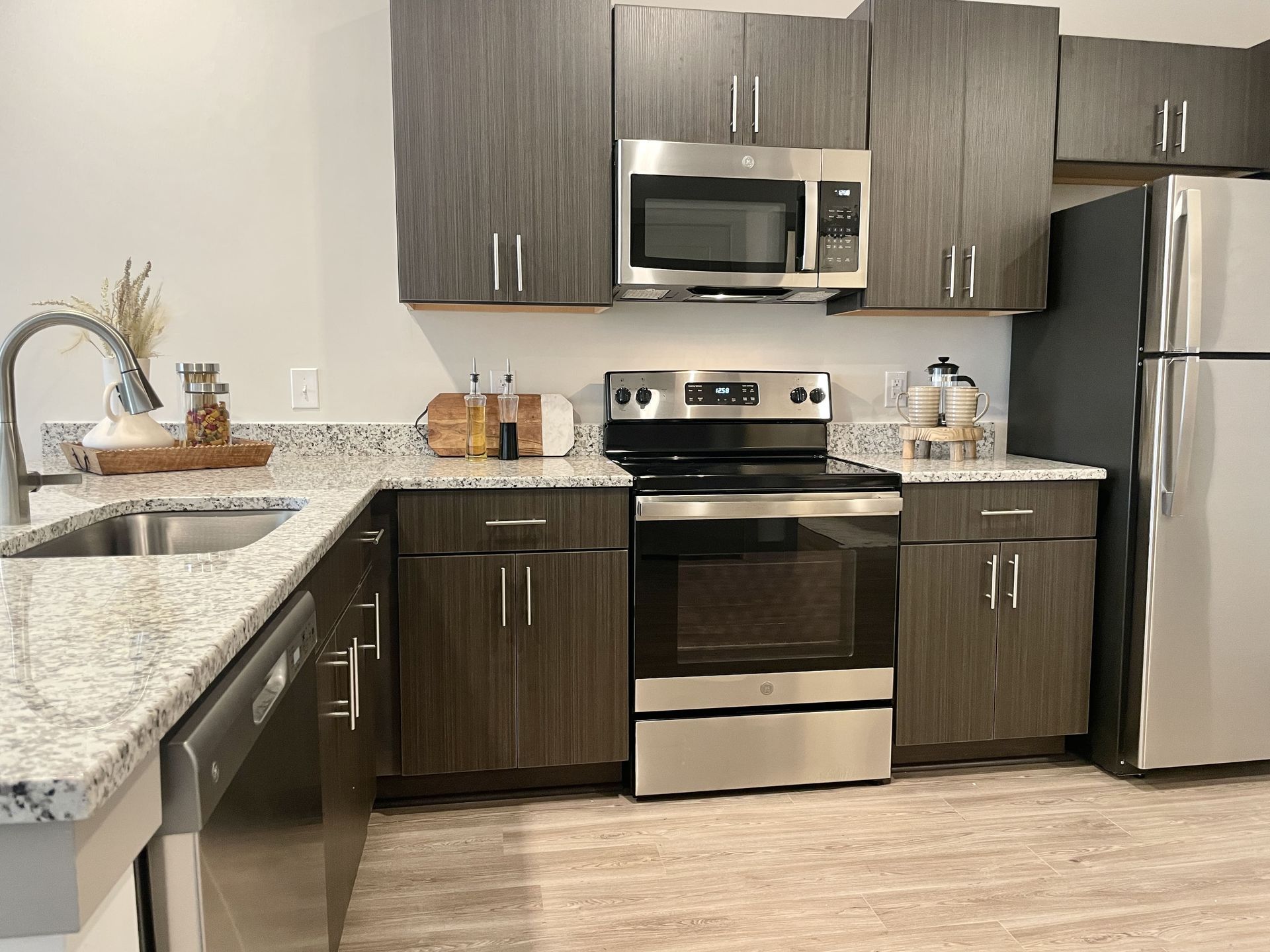 A kitchen with stainless steel appliances and granite counter tops.