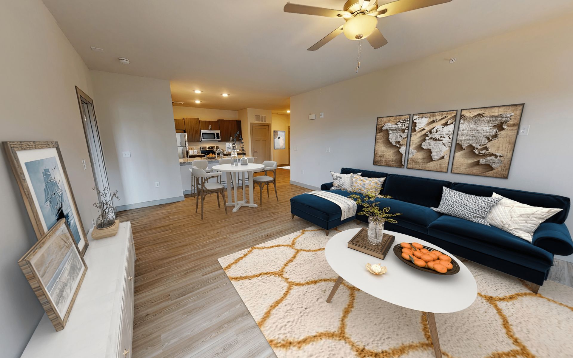 A living room with a couch , coffee table , and ceiling fan.