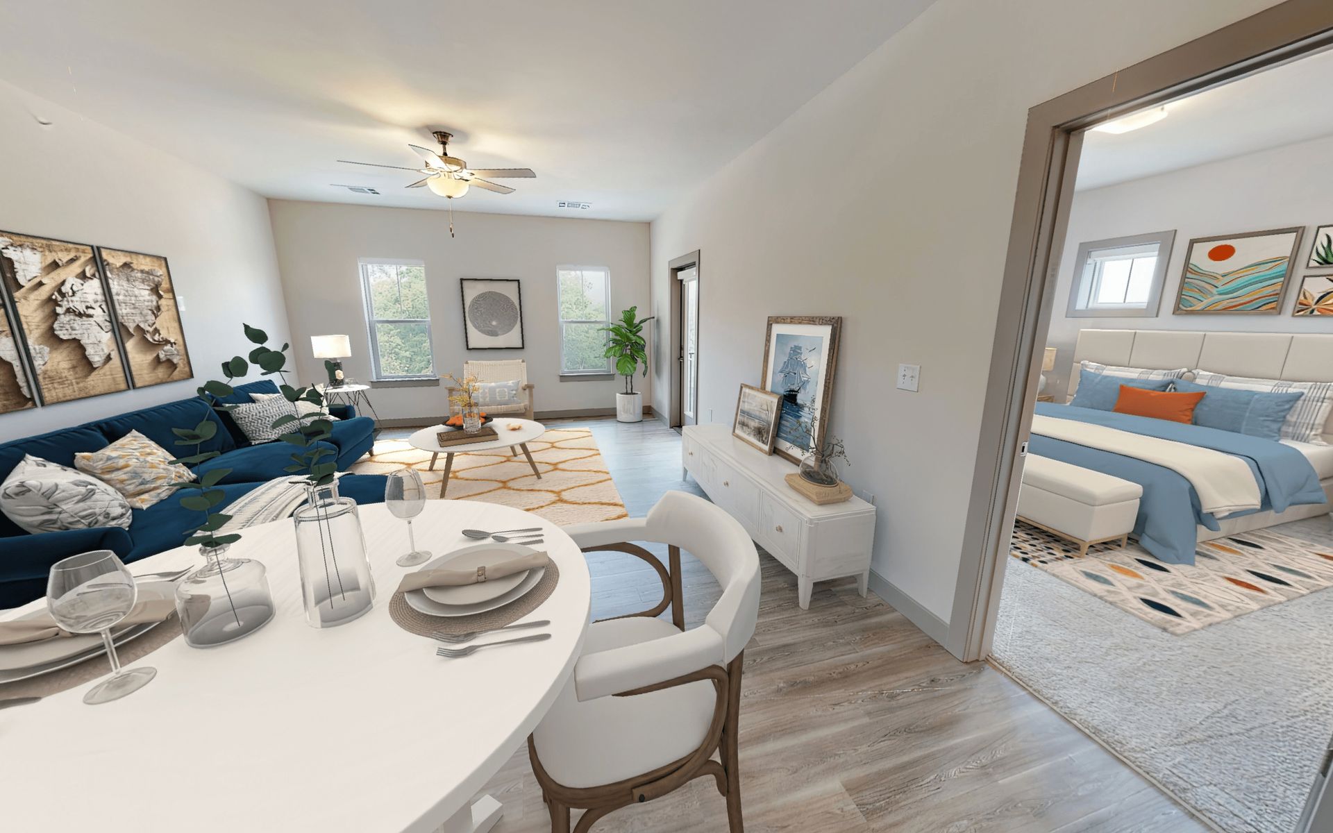 A living room with a dining table and chairs and a bedroom.