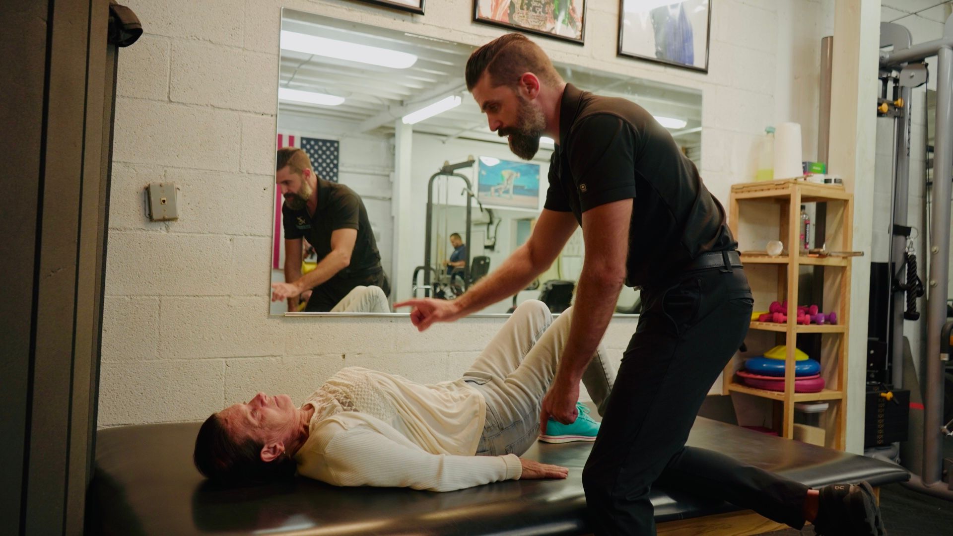 Doctor showing spinal model to patient with back pain.