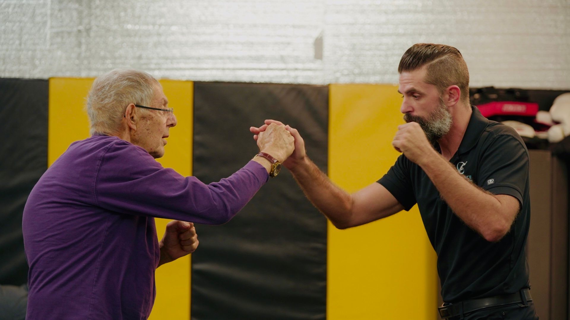 Woman receiving back therapy treatment with a handheld device, in a medical setting.