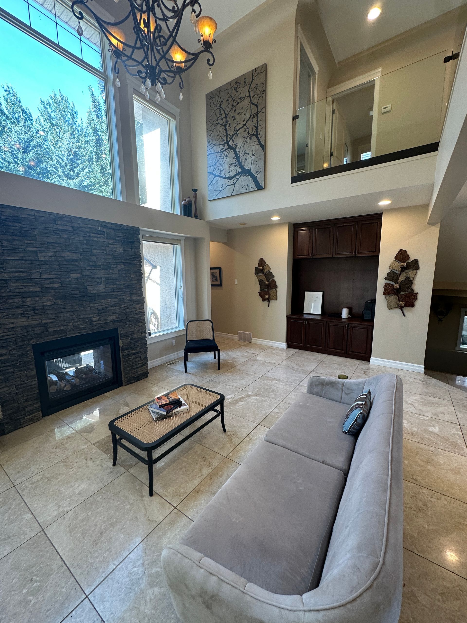 A living room with a couch , coffee table and fireplace