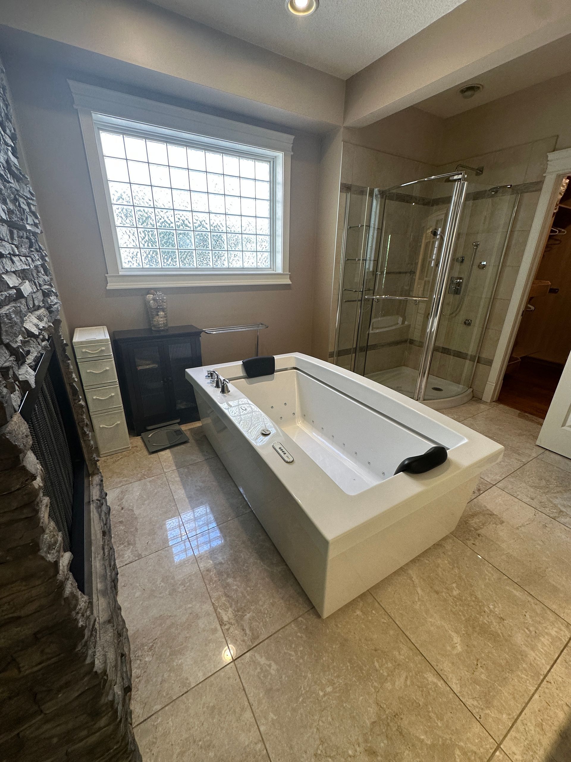 There is a large bathtub in the middle of the bathroom.