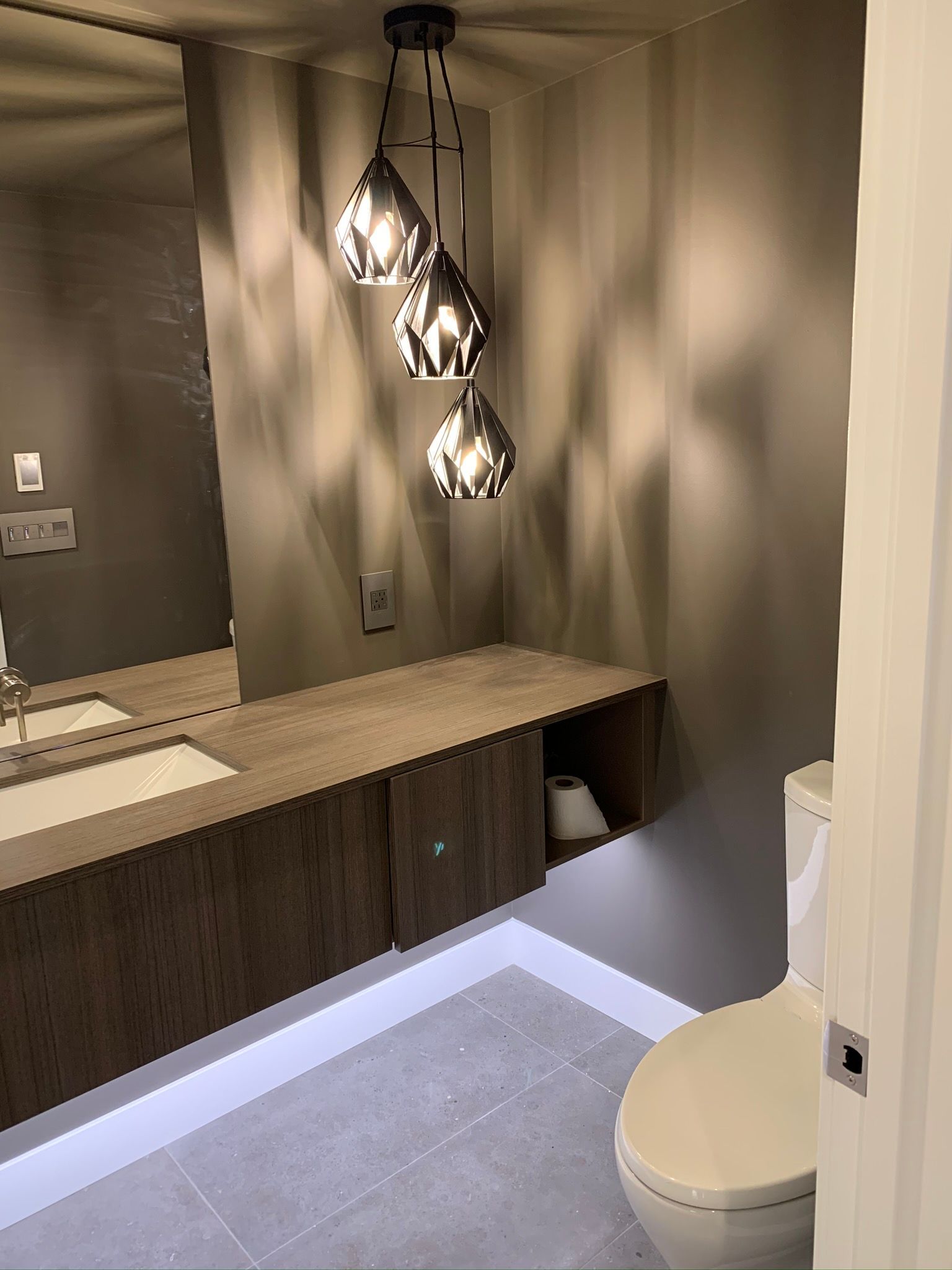 A living room with a ceiling fan and stairs.