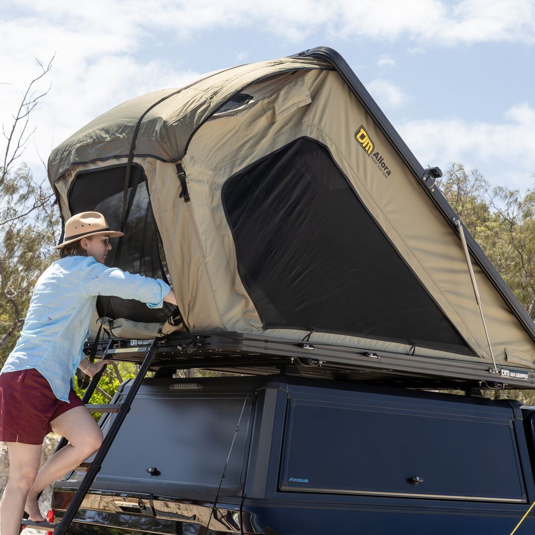 A Person is Setting Up a Rooftop Tent on a Black Truck — TJM Wagga Wagga In Ashmont, NSW