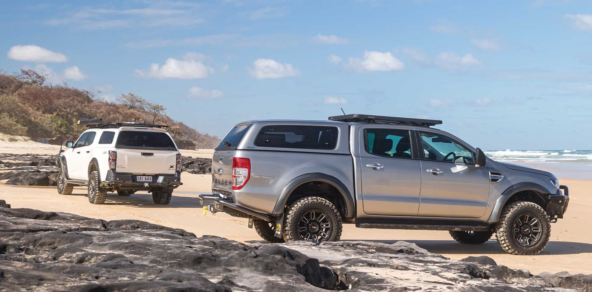 Two Trucks Driving on a Beach on a Sunny Day — TJM Wagga Wagga In Ashmont, NSW
