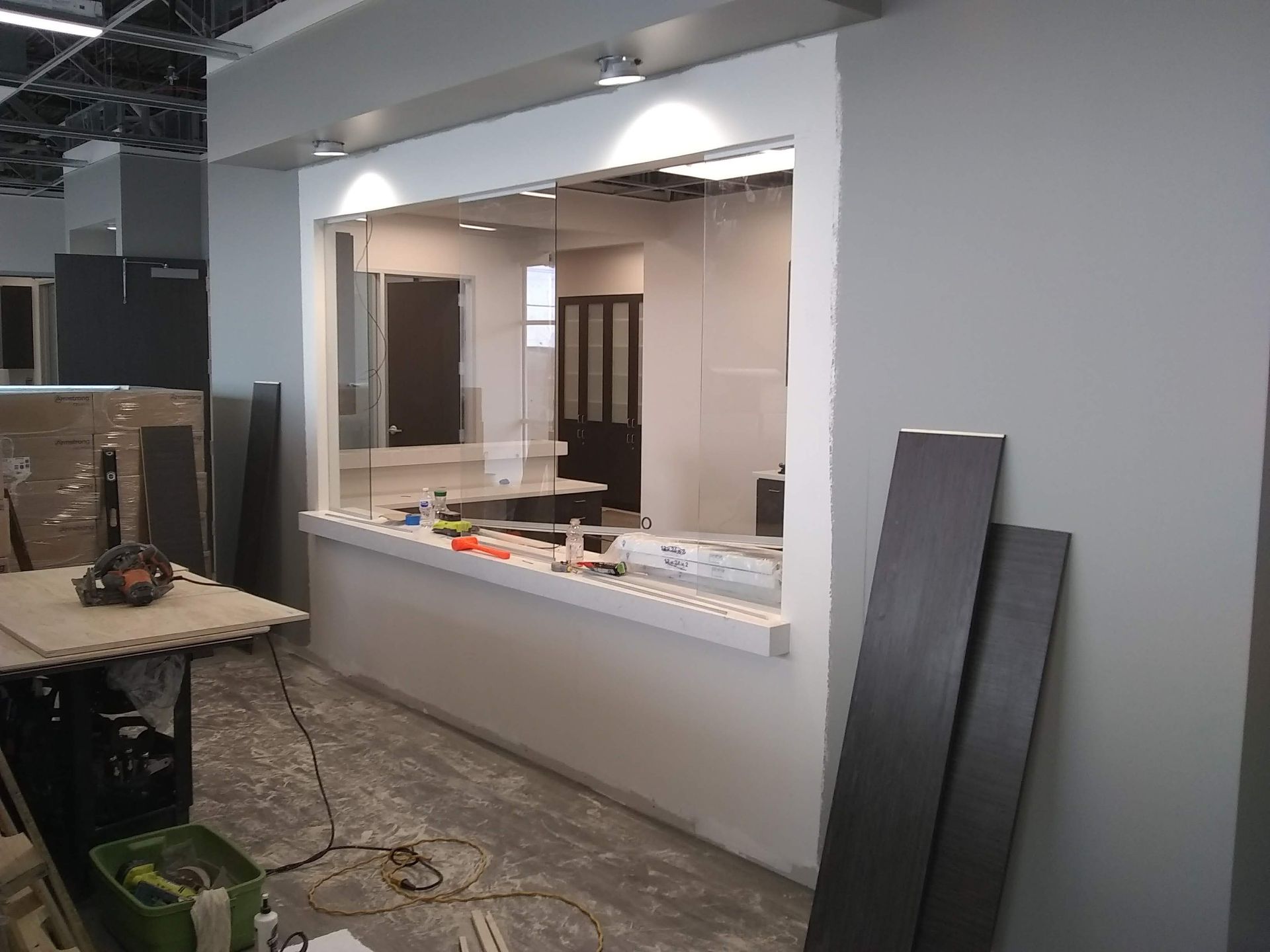 A room with a counter and a window in it is being remodeled.