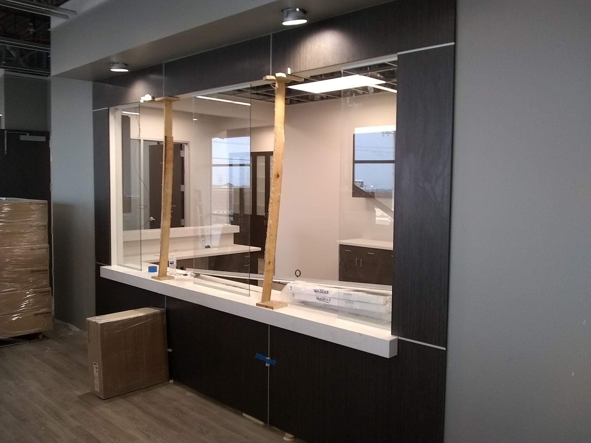 A room with a counter and a glass wall.