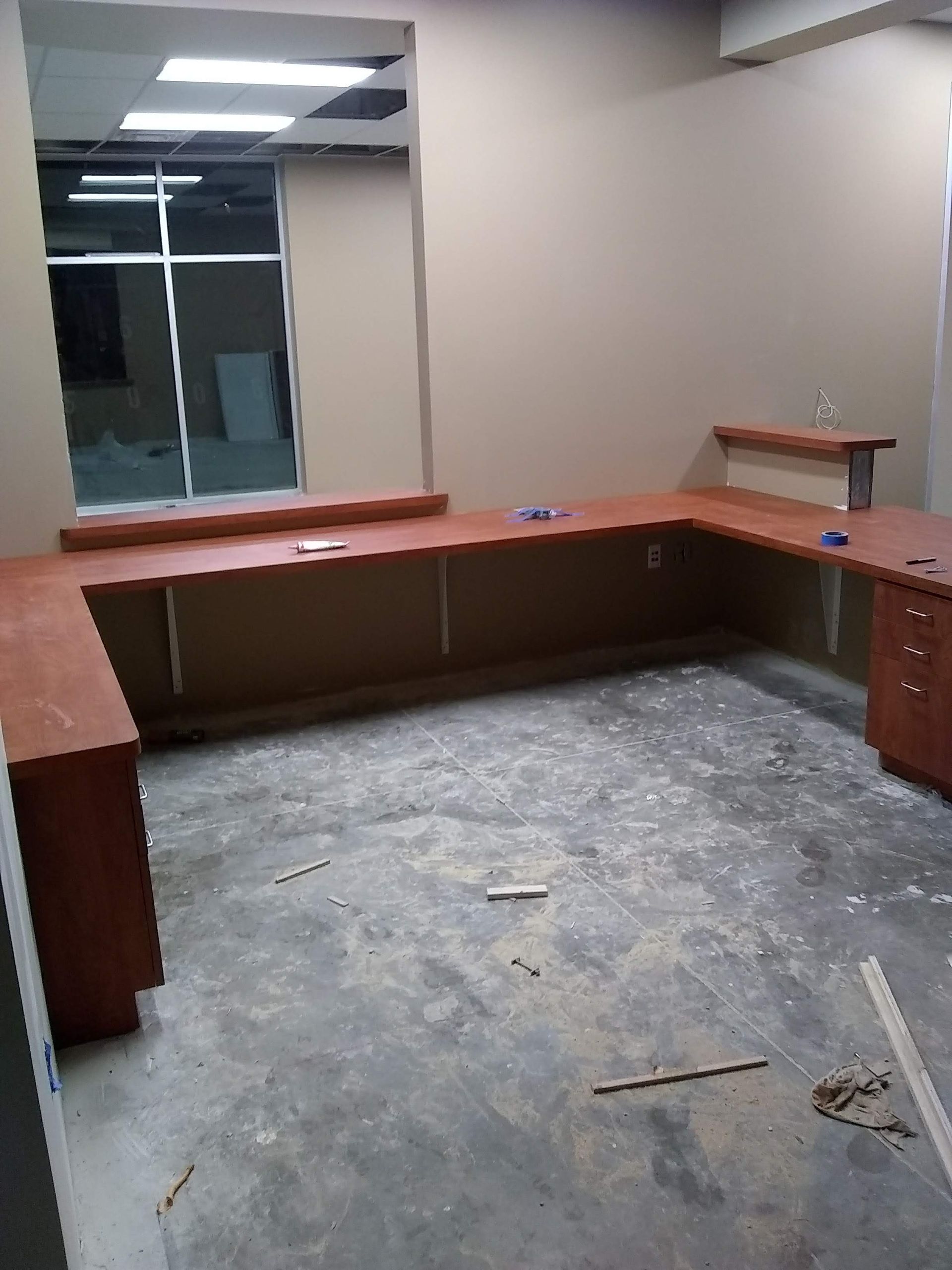 An empty room with a desk and a window.