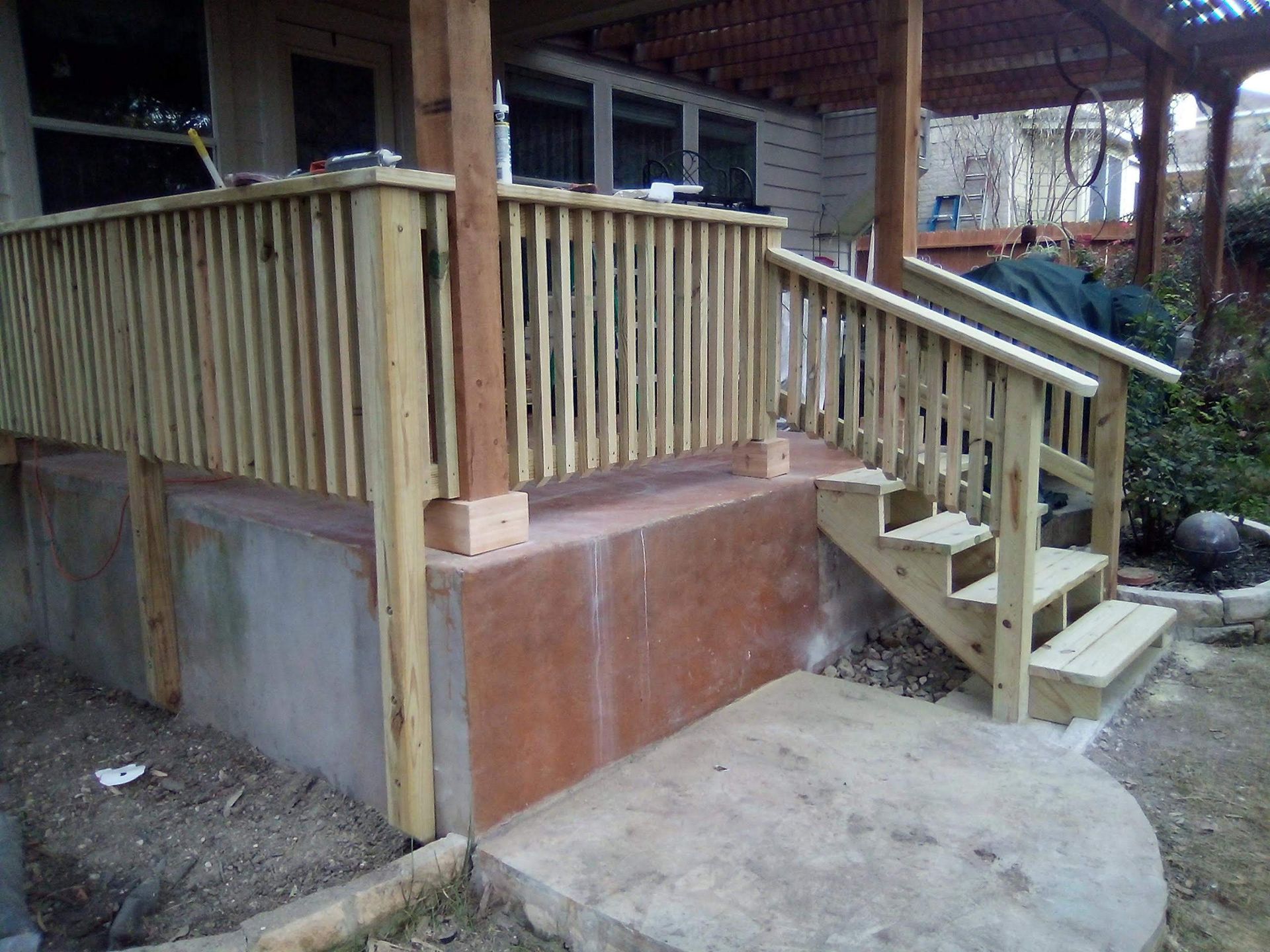 A wooden deck with stairs leading up to it