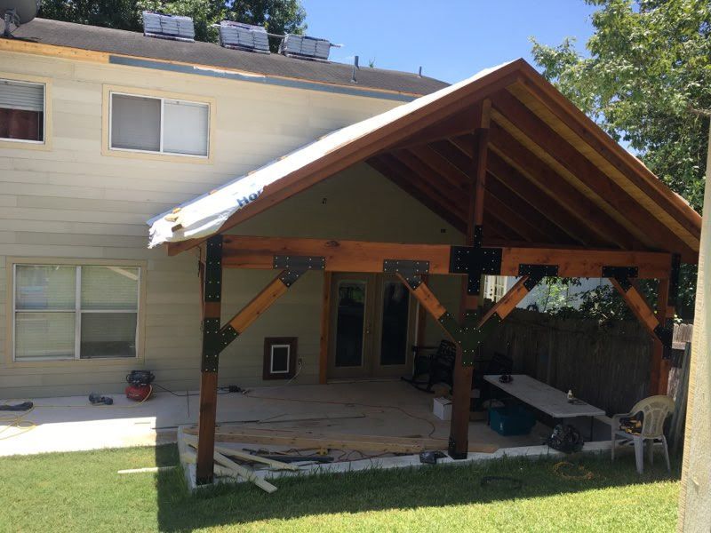 A house with a covered patio in front of it