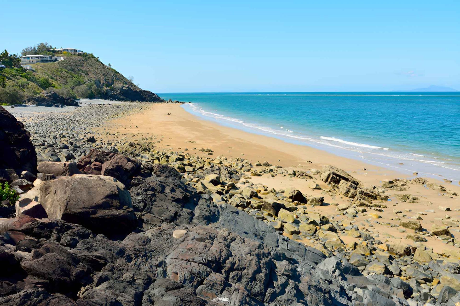 A Rocky Beach With A Large Rock In The Foreground— Wallers Precision Tooling In Paget , QLD
