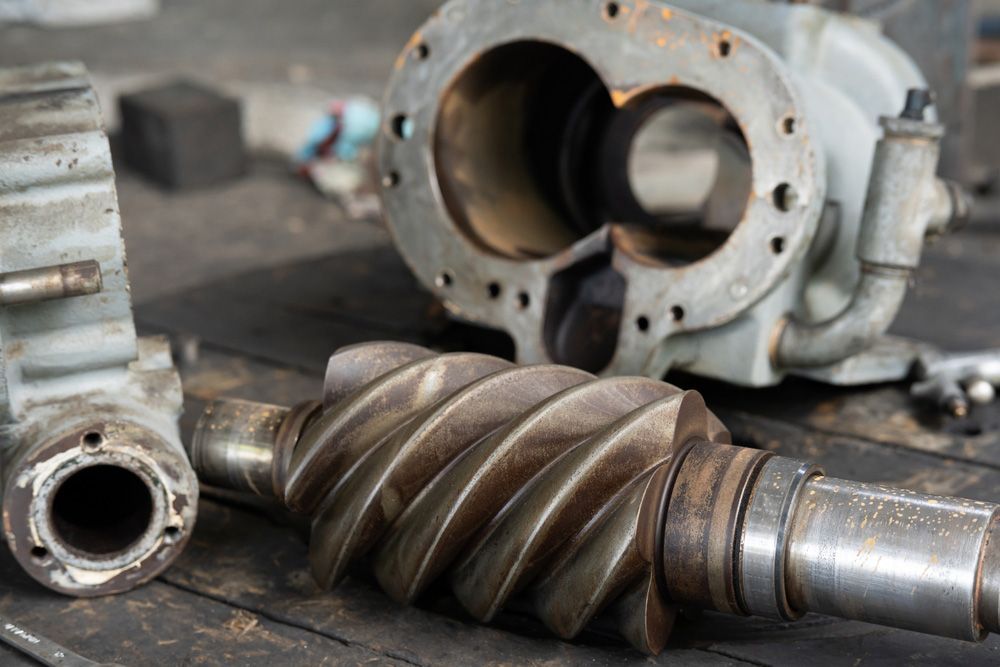 A Close Up Of A Gear And A Compressor On A Table — Wallers Precision Tooling In Moranbah, QLD