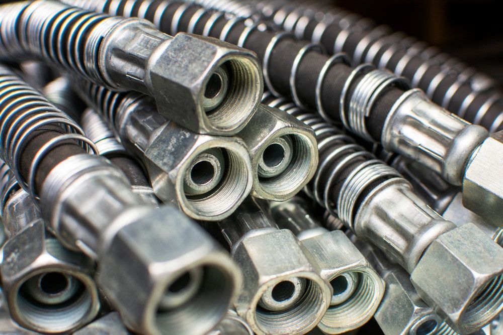 A Bunch Of Hydraulic Hoses Are Stacked On Top Of Each Other — Wallers Precision Tooling In Moranbah, QLD