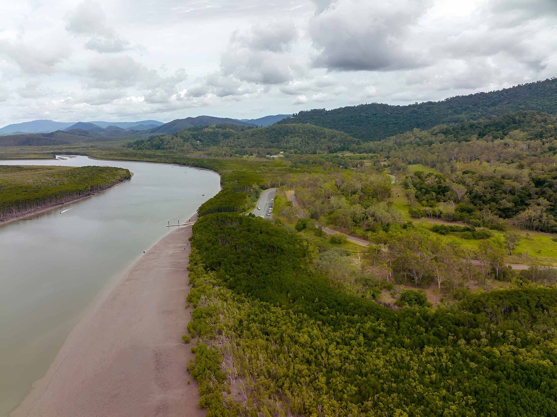 An Aerial View Of A River Surrounded By Trees And Mountains — Wallers Precision Tooling In Proserpine, QLD