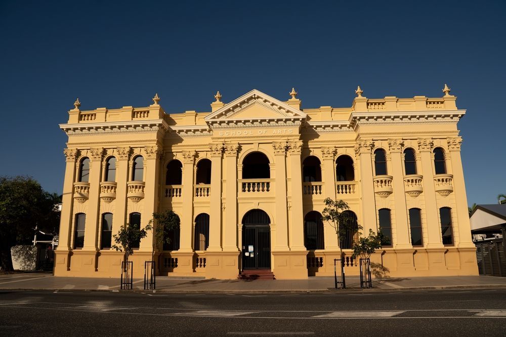 A Large Yellow Building With A Blue Sky In The Background — Wallers Precision Tooling In Rockhampton, QLD