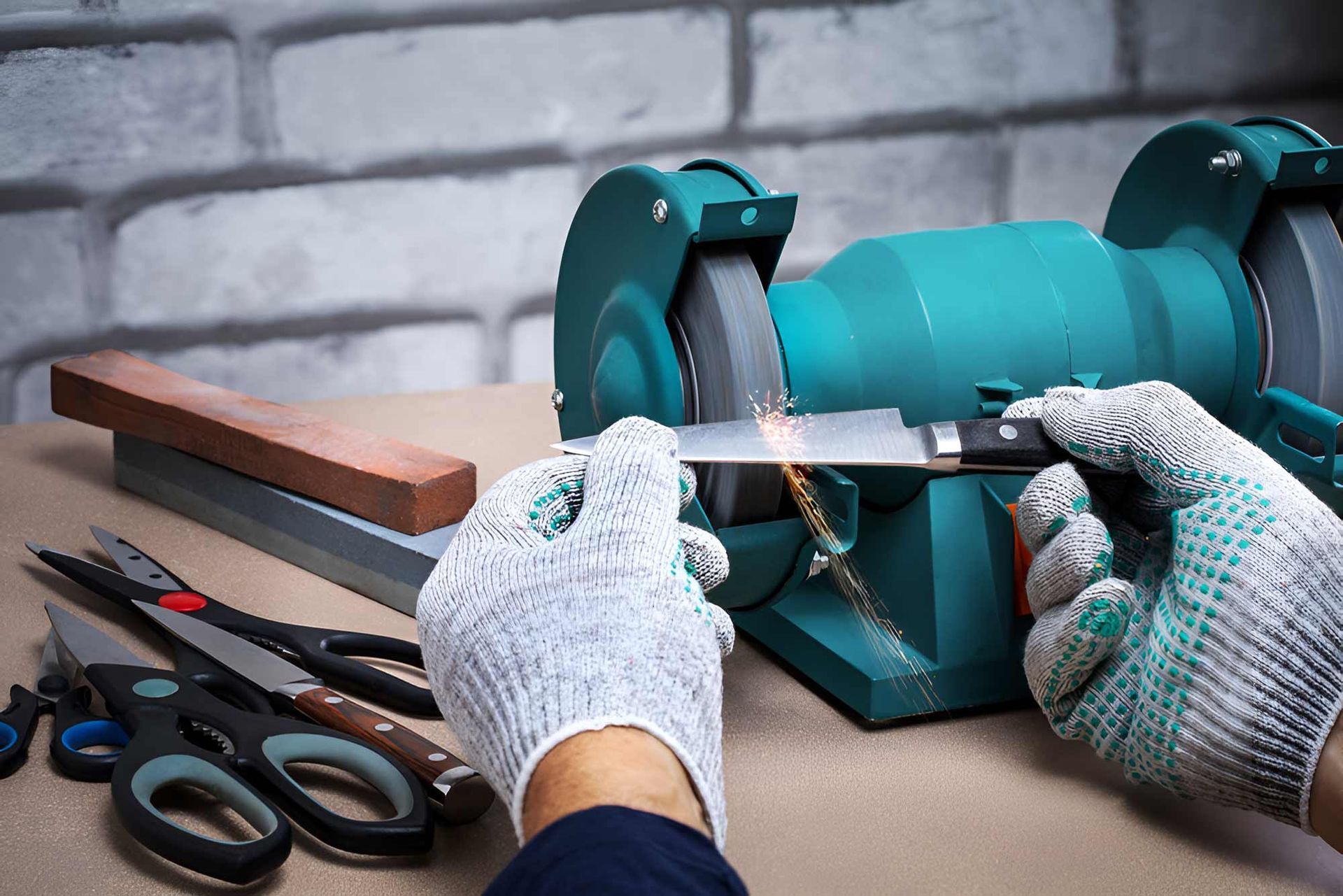 A Person Is Sharpening A Pair Of Scissors On A Grinder — Wallers Precision Tooling In Mackay, QLD
