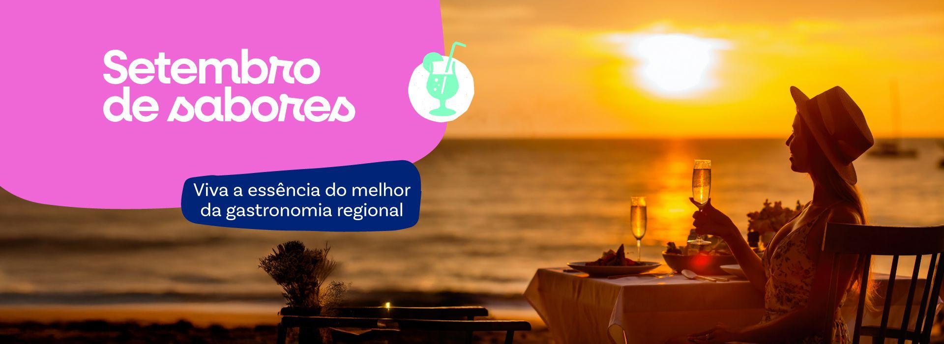 Uma mulher está sentada em uma mesa na praia segurando uma taça de vinho.