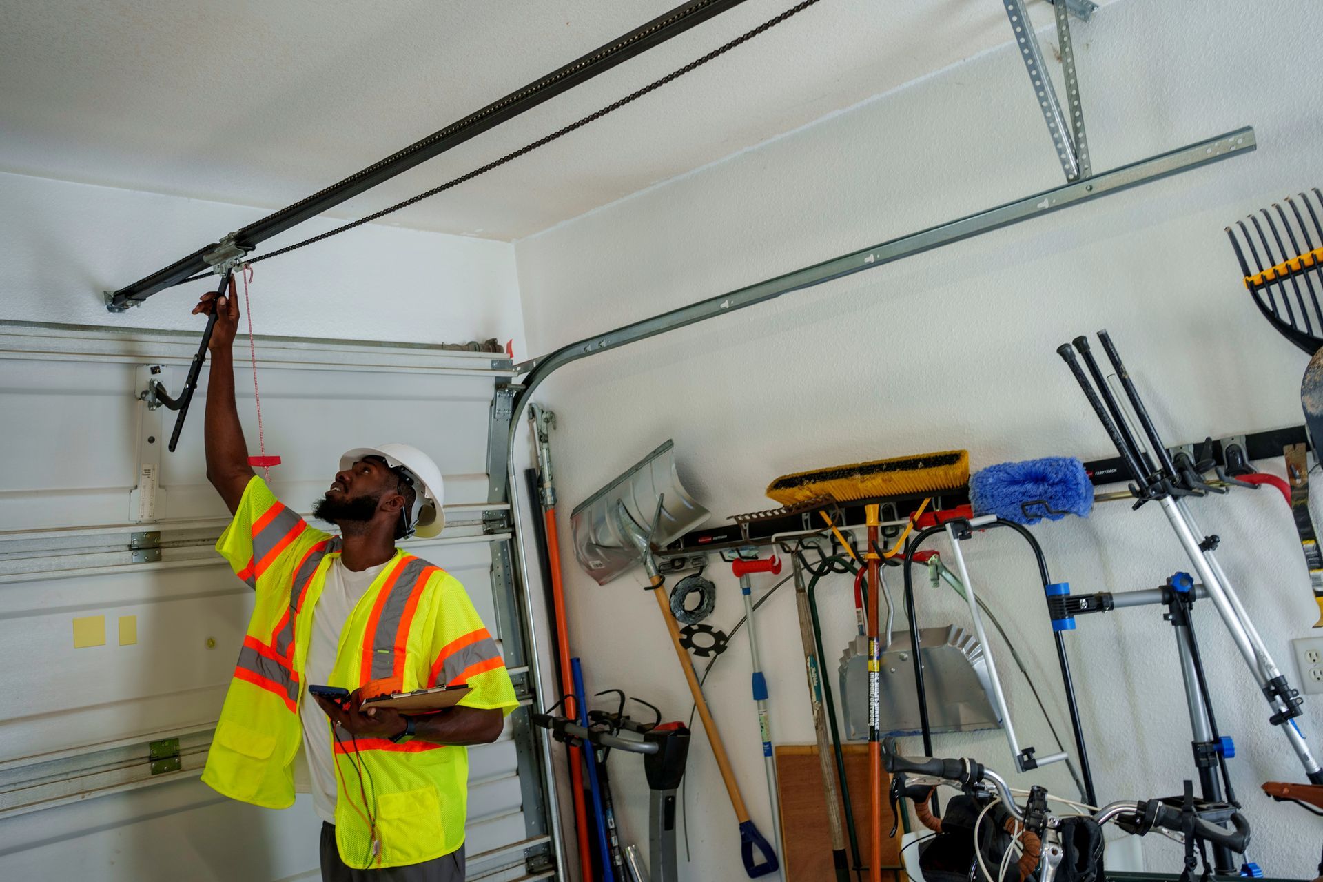 A worker is inspecting a garage door.