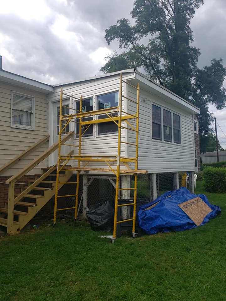 A house with a yellow scaffolding on the side of it