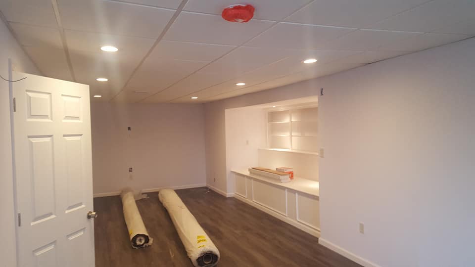 There are two rolls of carpet in the middle of the room.