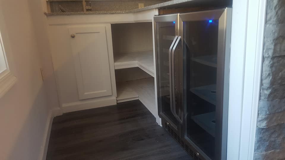 A kitchen with a refrigerator and a wine cooler.