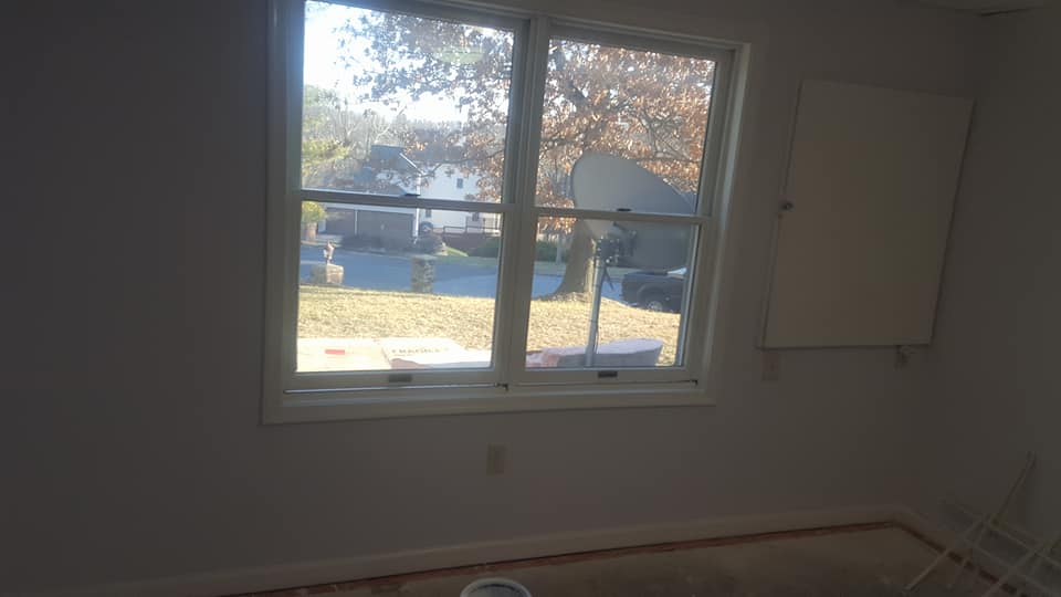 A room with a window and a satellite dish on the wall.
