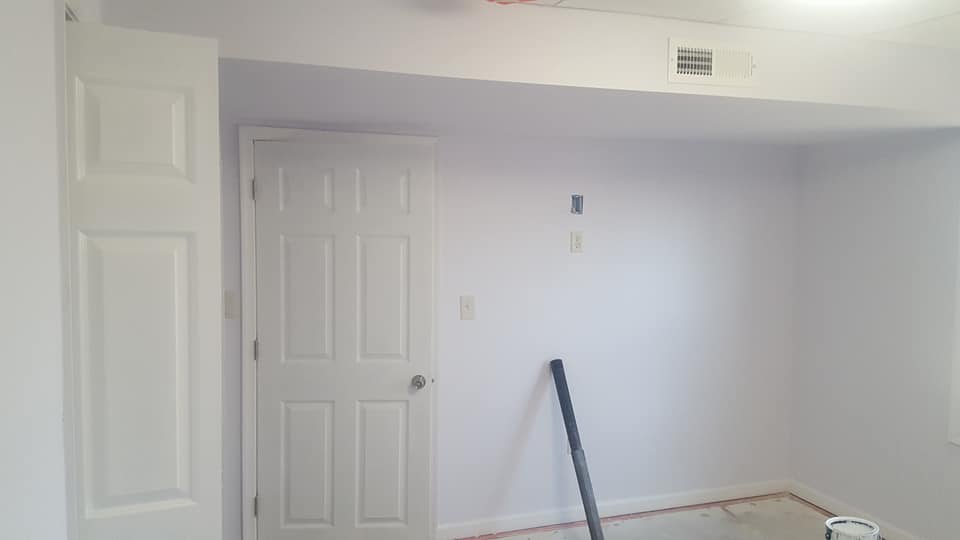 A room with white walls and a white door.