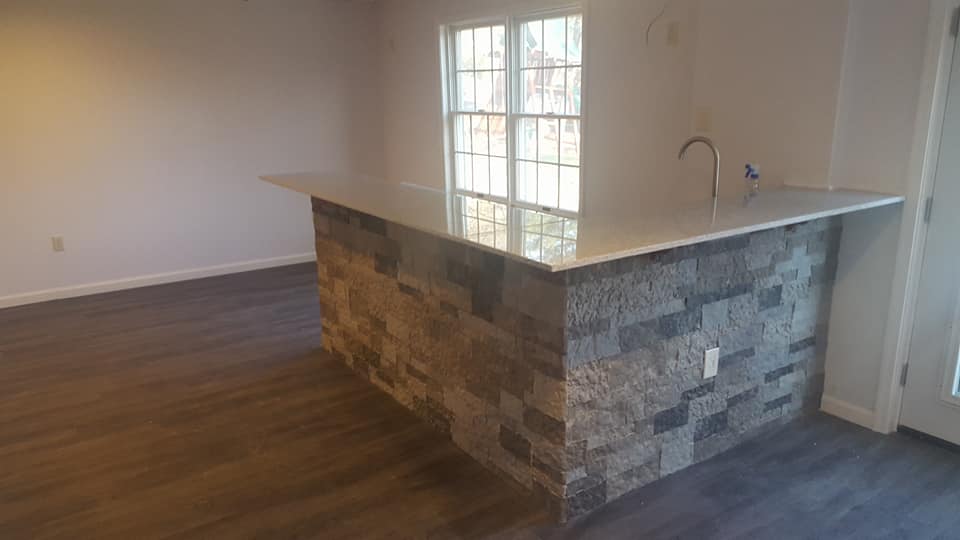 A kitchen with a large island in the middle of the room.