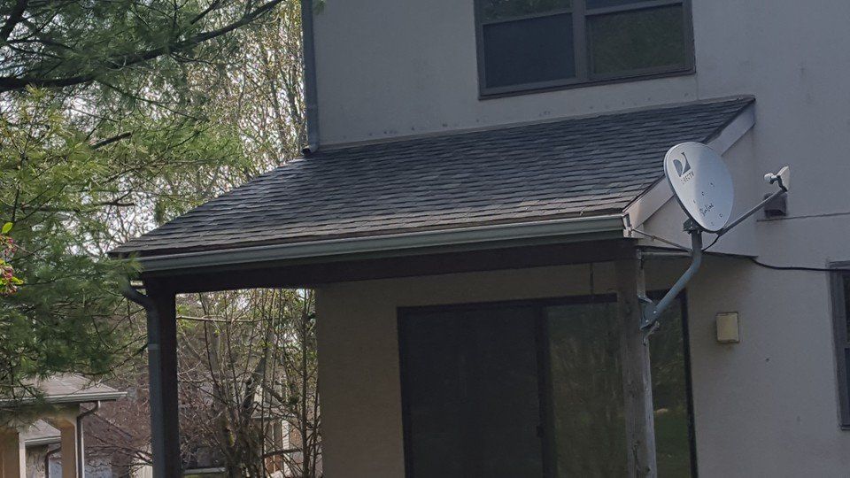 A house with a satellite dish on the side of it.