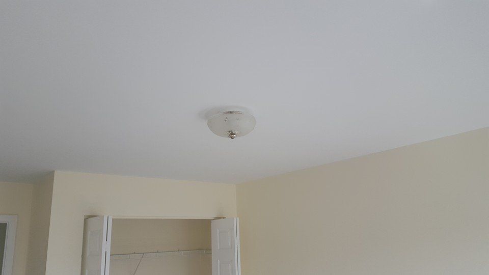 A light fixture is hanging from the ceiling of a room.