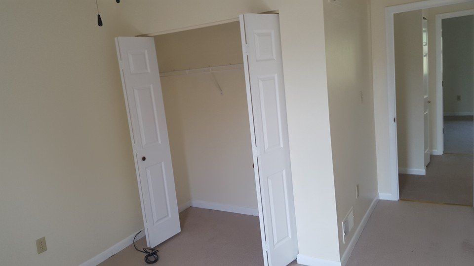 There is a closet in the middle of the room with the doors open.