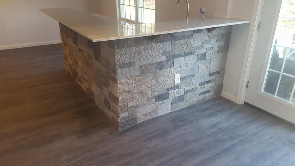 A kitchen with a large island in the middle of the room.