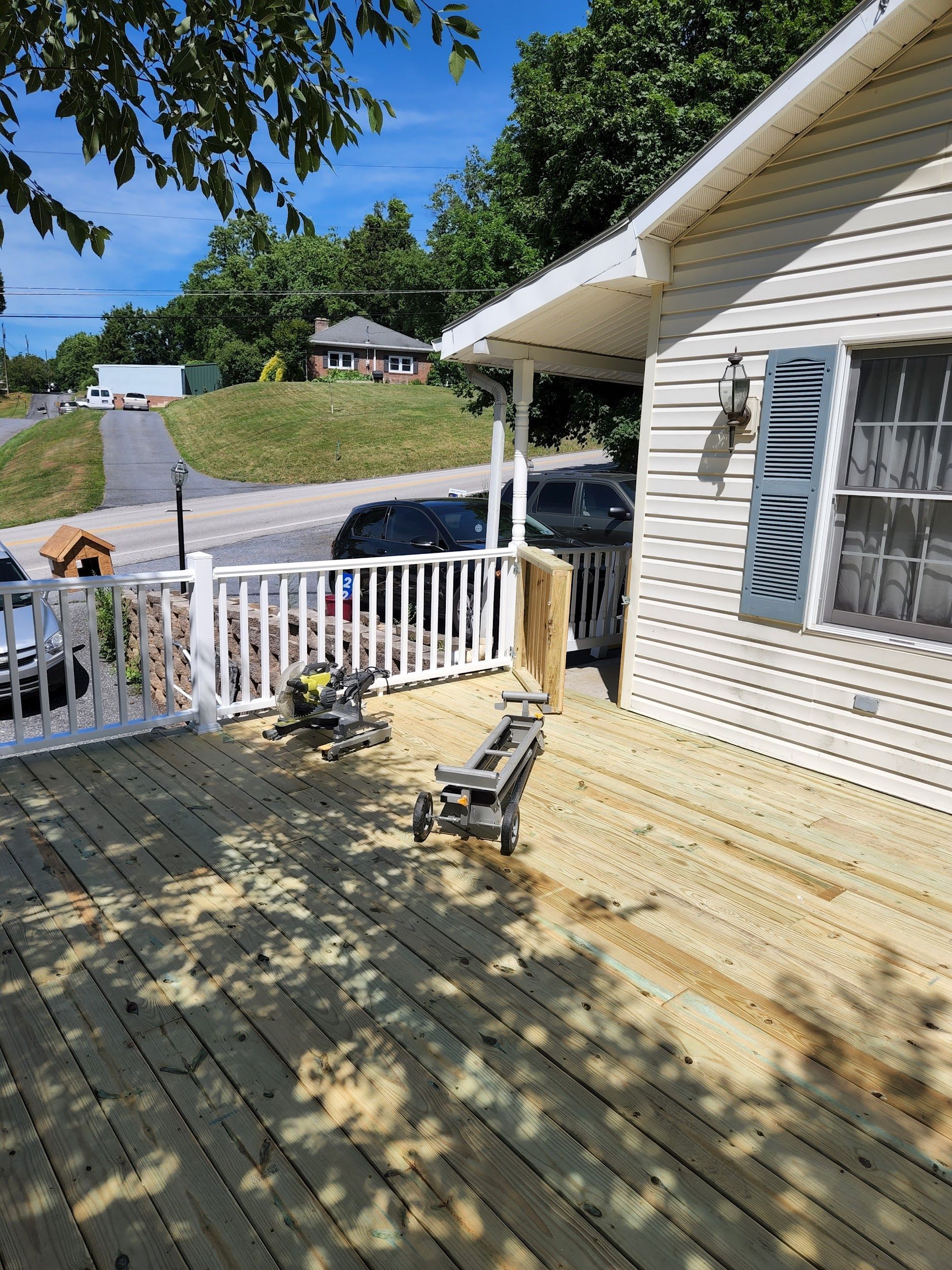A wooden deck is being built on the side of a house.