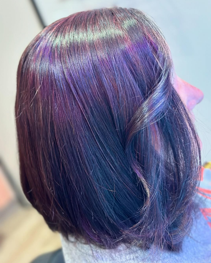 Close-up of styled hair with a mix of purple, magenta, and dark blue tones.