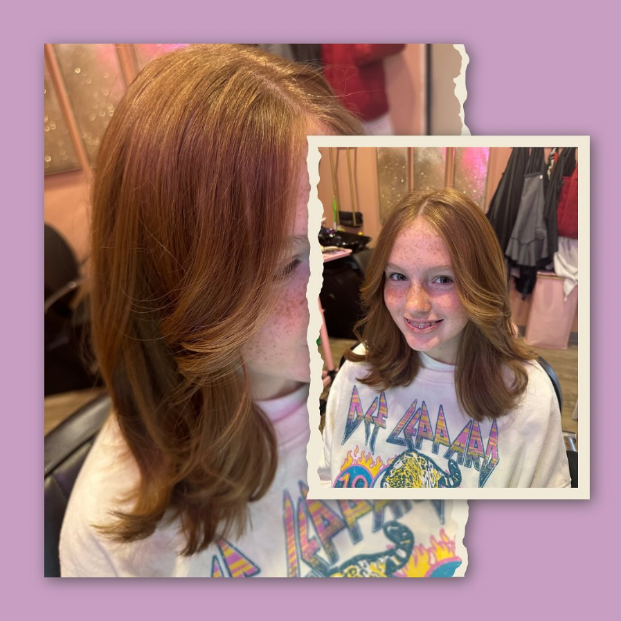 Woman with layered auburn hair in a salon setting. Smiling, wearing a patterned shirt.