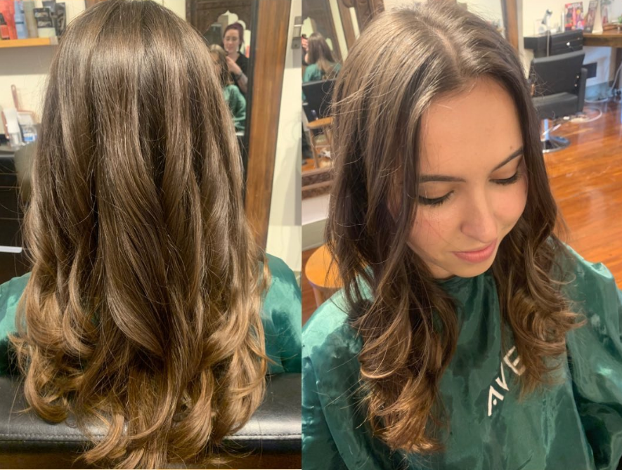 Woman with wavy brown hair, styled at a salon.