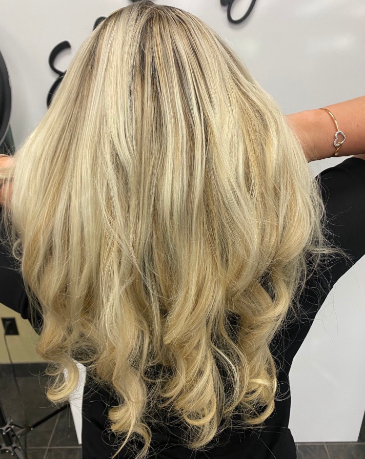 Blonde hair with crimped roots and wavy ends, back view.