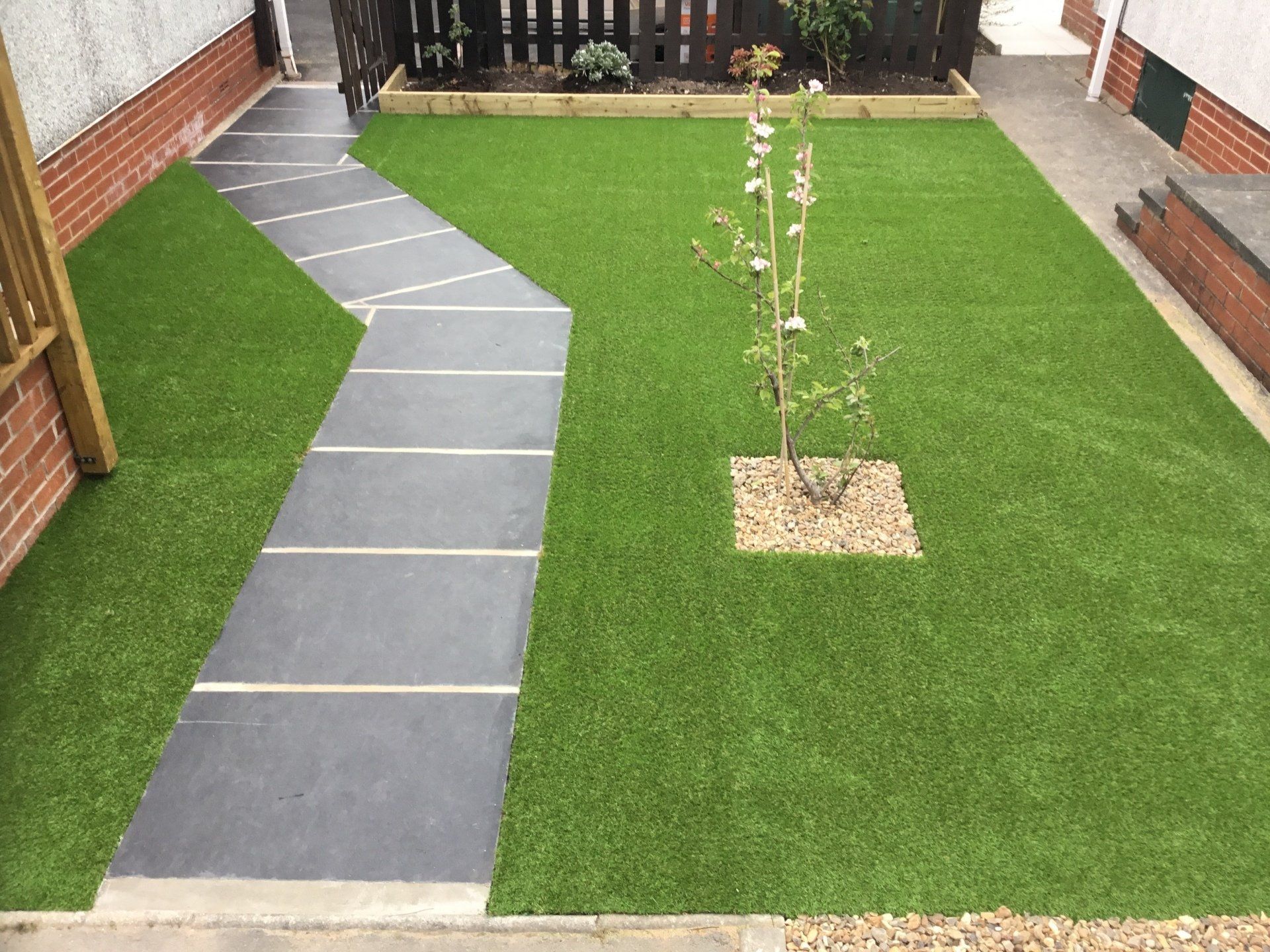 indian sandstone path with artificial lawn in knott end near blackpool