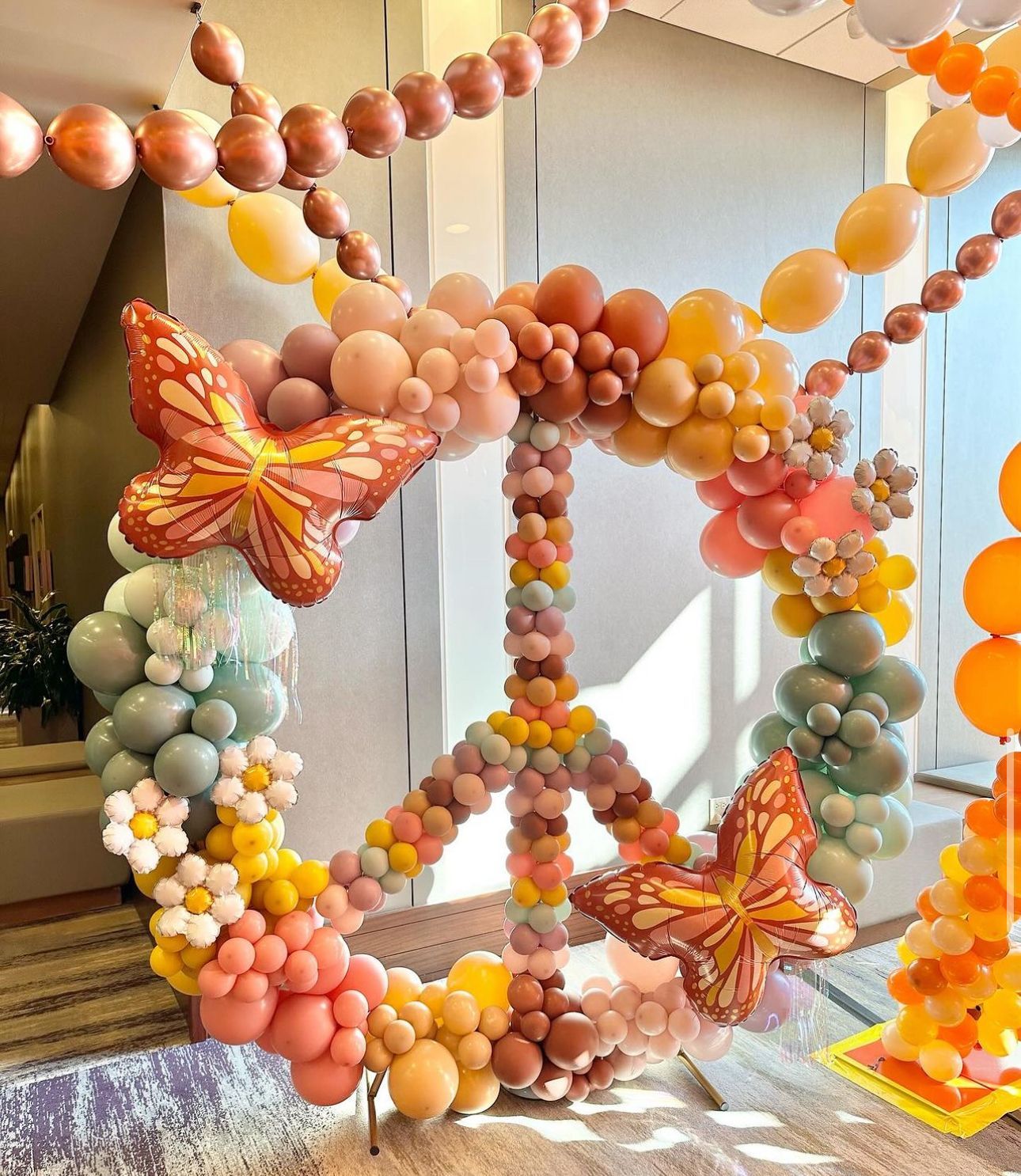 A peace sign made of balloons and butterflies