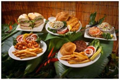 A variety of plates of food are sitting on a table.